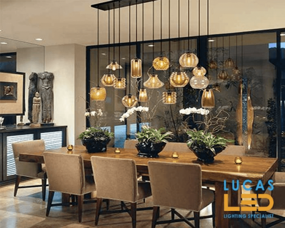 Variously Shaped Pendant Lamps Above A Dining Table