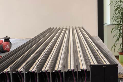 Custom-cut aluminium LED profiles with installed LED strips and soldered cables ready for installation
